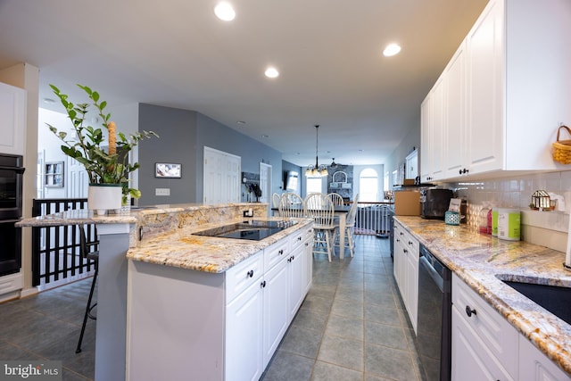 350 Rotterham Dr, Hedgesville, WV 25427 - kitchen with white cabinetry, recessed lighting, black appliances, and a kitchen bar