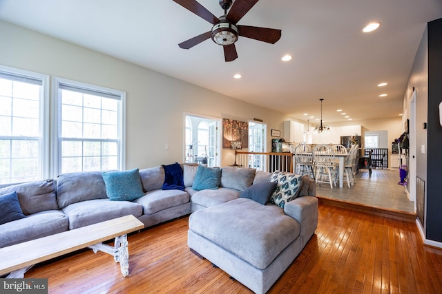 350 Rotterham Dr, Hedgesville, WV 25427 - living room featuring light wood-type flooring, recessed lighting, and ceiling fan with notable chandelier
