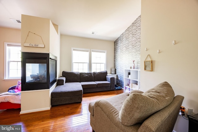 350 Rotterham Dr, Hedgesville, WV 25427 - living area with visible vents, a multi sided fireplace, hardwood / wood-style flooring, and baseboards
