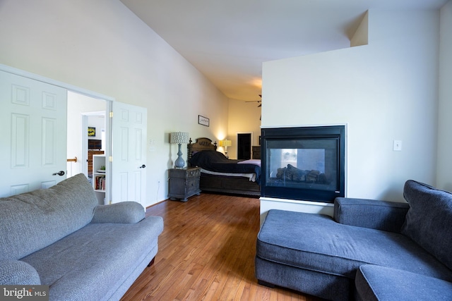 350 Rotterham Dr, Hedgesville, WV 25427 - living area featuring a multi sided fireplace, wood finished floors, and a ceiling fan