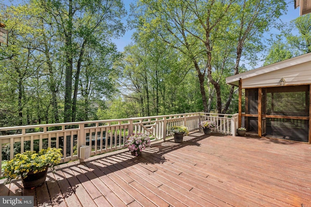 wooden deck featuring a sunroom