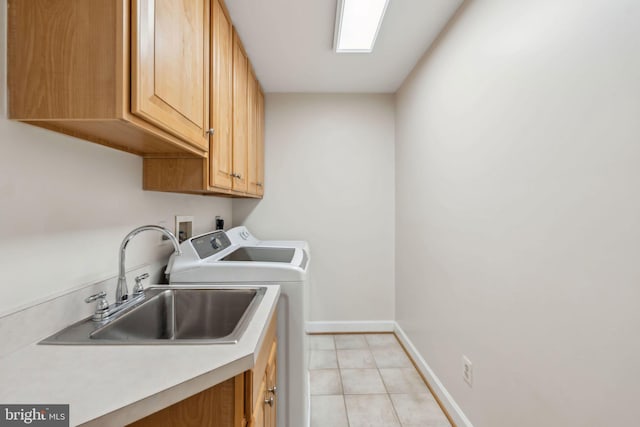laundry room with a sink, cabinet space, independent washer and dryer, light tile patterned flooring, and baseboards