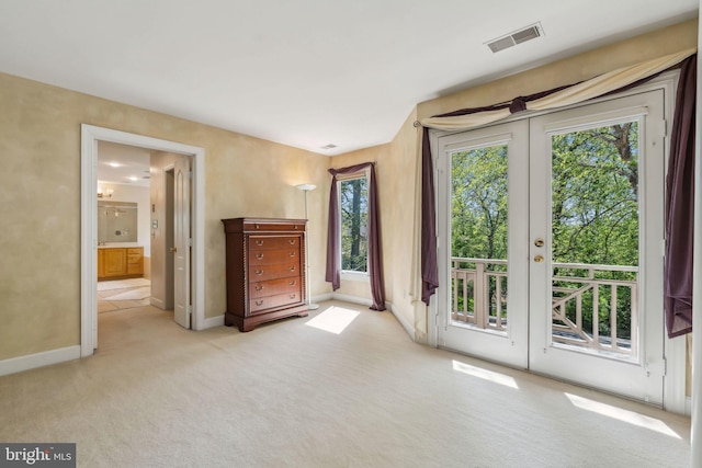 doorway to outside with baseboards, visible vents, carpet floors, and french doors