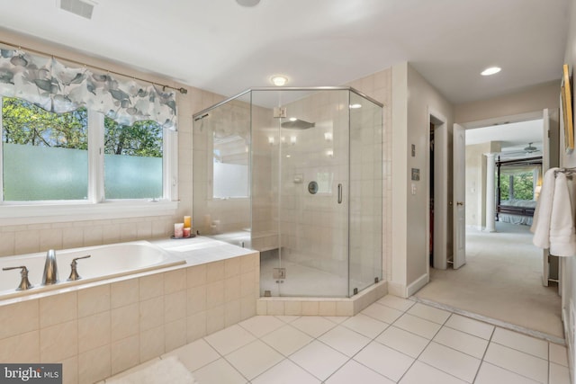 bathroom with a wealth of natural light, visible vents, a bath, and tile patterned flooring