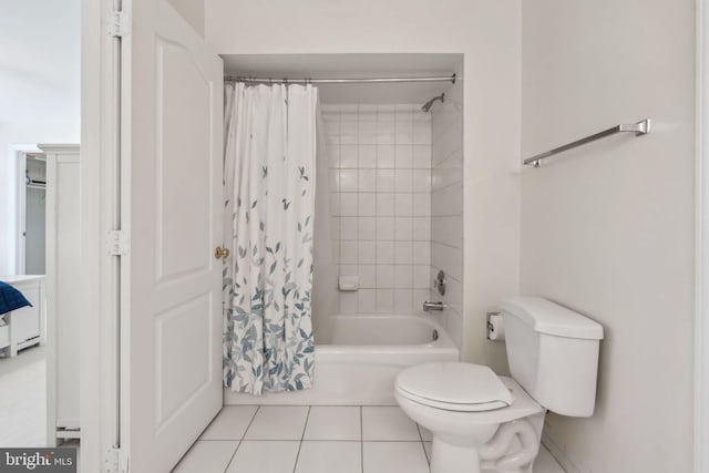bathroom with shower / tub combo with curtain, toilet, and tile patterned flooring