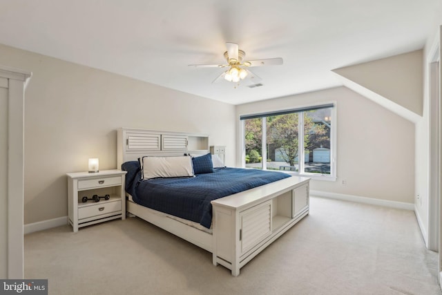 bedroom featuring a ceiling fan, light colored carpet, and baseboards