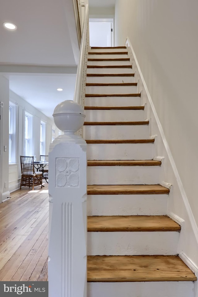 stairway featuring recessed lighting and hardwood / wood-style flooring