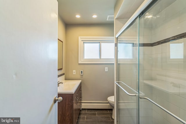 bathroom featuring a baseboard heating unit, a shower stall, toilet, vanity, and visible vents