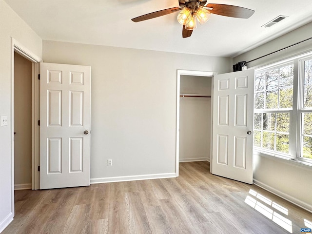 276 Rustling Oaks Way, Ruckersville, VA 22968 - unfurnished bedroom with light wood-type flooring, visible vents, and multiple windows