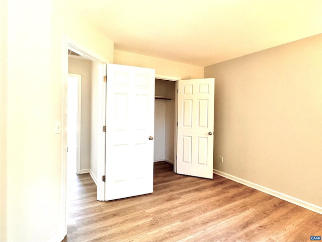 276 Rustling Oaks Way, Ruckersville, VA 22968 - unfurnished bedroom featuring baseboards, a closet, and light wood-style flooring