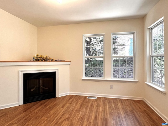 276 Rustling Oaks Way, Ruckersville, VA 22968 - unfurnished living room with a wealth of natural light, wood finished floors, visible vents, and a fireplace