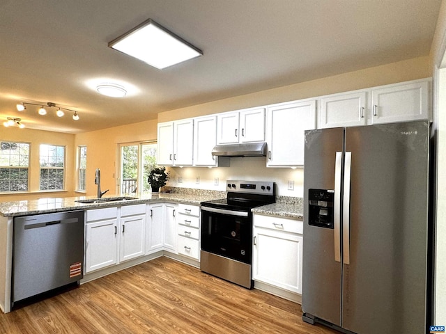 276 Rustling Oaks Way, Ruckersville, VA 22968 - kitchen with white cabinets, under cabinet range hood, a sink, and appliances with stainless steel finishes