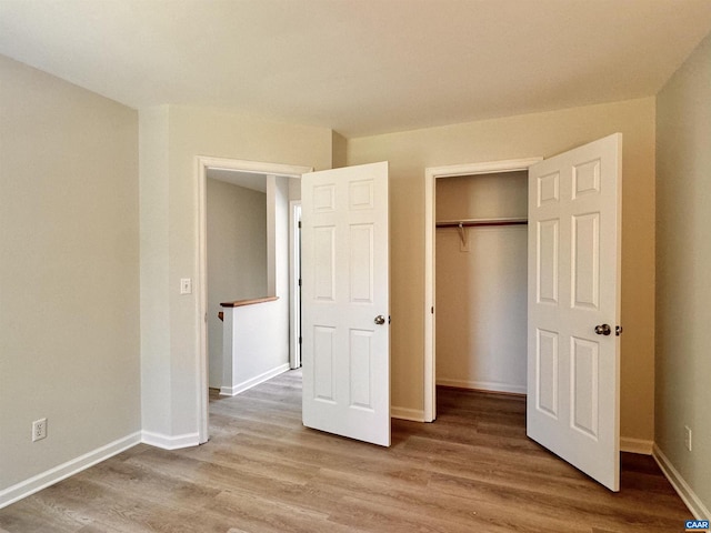 276 Rustling Oaks Way, Ruckersville, VA 22968 - unfurnished bedroom featuring wood finished floors, a closet, and baseboards