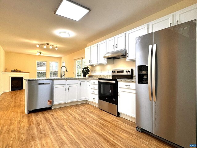 276 Rustling Oaks Way, Ruckersville, VA 22968 - kitchen with light wood finished floors, white cabinets, a sink, under cabinet range hood, and appliances with stainless steel finishes