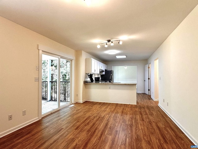 276 Rustling Oaks Way, Ruckersville, VA 22968 - unfurnished living room with baseboards and dark wood-style floors
