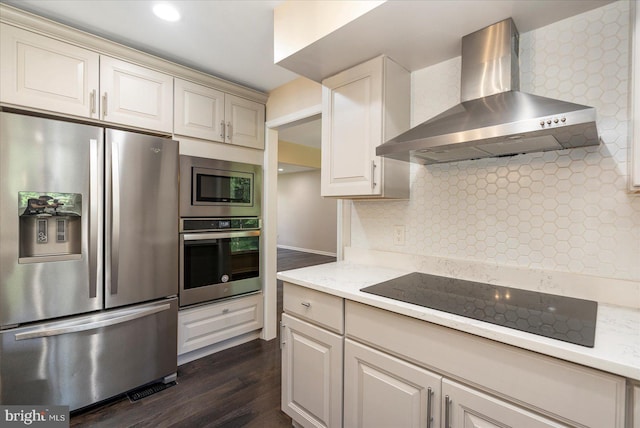 4 Brian Daniel Ct, Reisterstown, MD 21136 - kitchen featuring stainless steel appliances, wall chimney range hood, dark wood finished floors, tasteful backsplash, and cream cabinetry