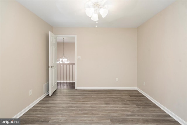 4 Brian Daniel Ct, Reisterstown, MD 21136 - spare room featuring wood finished floors, ceiling fan, and a chandelier