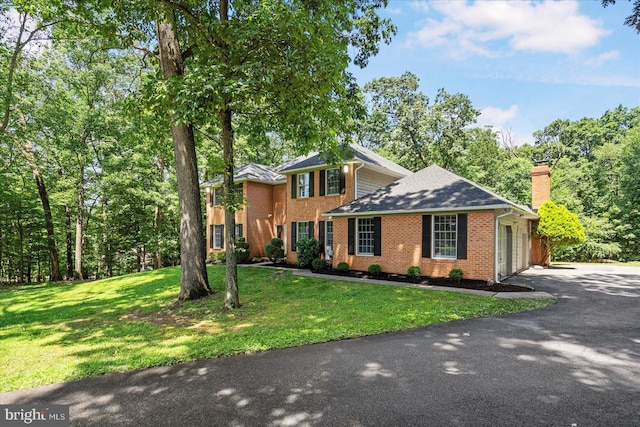 4 Brian Daniel Ct, Reisterstown, MD 21136 - colonial home with driveway, an attached garage, a chimney, brick siding, and a front lawn