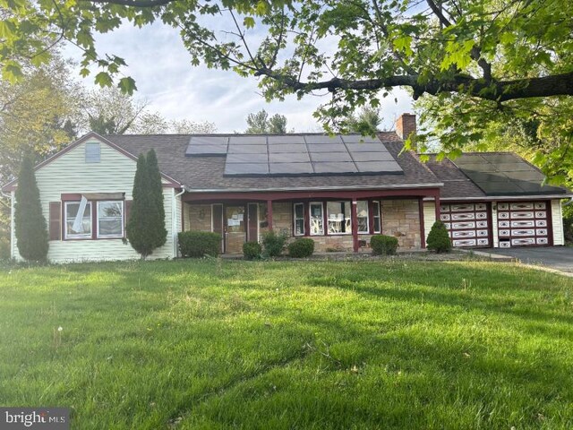 22 Trebing Ct, Willingboro, NJ 08046 - single story home featuring a garage, a chimney, aphalt driveway, roof mounted solar panels, and a front yard