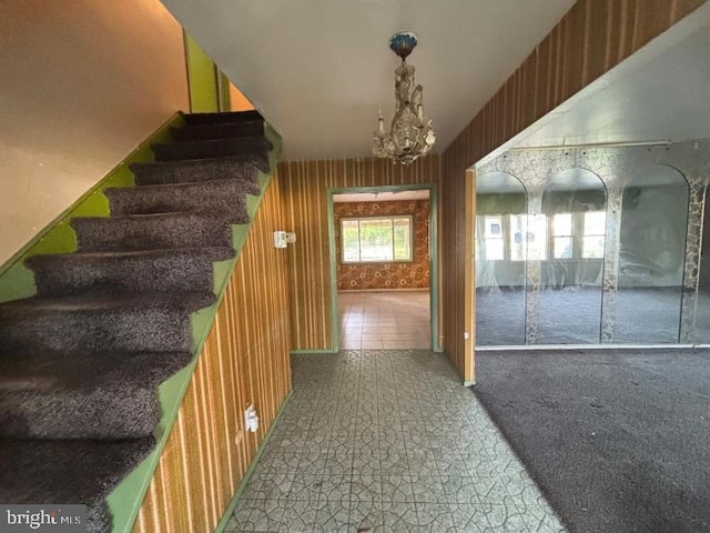 22 Trebing Ct, Willingboro, NJ 08046 - interior space with wood walls, a notable chandelier, and stairs