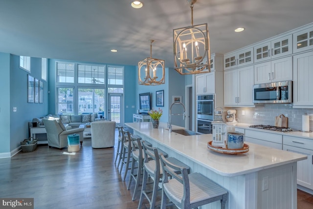 11520 Maull Rd Unit S-183, Lewes, DE 19958 - kitchen featuring an inviting chandelier, a kitchen island with sink, white cabinets, a sink, and appliances with stainless steel finishes