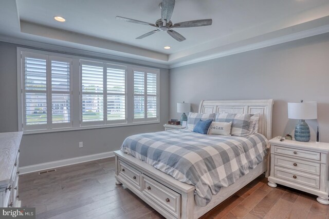 11520 Maull Rd Unit S-183, Lewes, DE 19958 - bedroom featuring baseboards, dark wood-style flooring, a tray ceiling, and visible vents