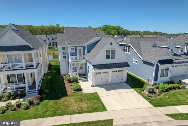 11520 Maull Rd Unit S-183, Lewes, DE 19958 - view of front facade featuring a shingled roof, a front yard, a balcony, a standing seam roof, and driveway