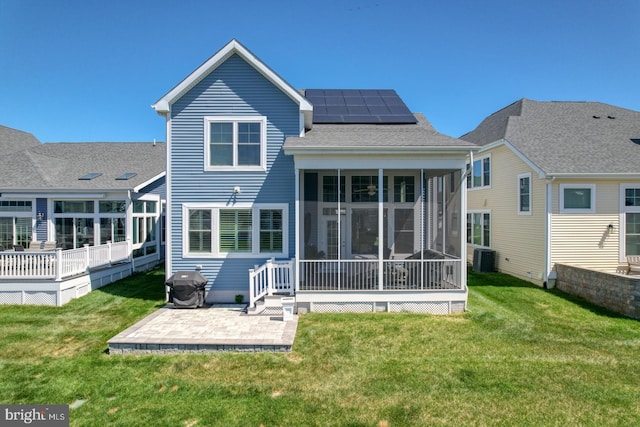 11520 Maull Rd Unit S-183, Lewes, DE 19958 - back of property with a lawn, a sunroom, solar panels, and a patio area