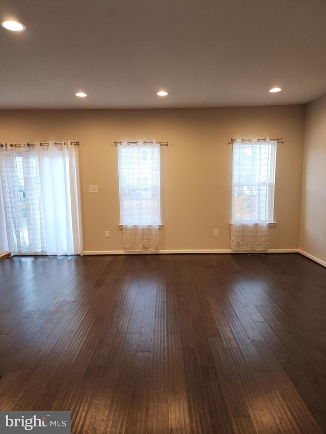 unfurnished room featuring baseboards, recessed lighting, and dark wood-style flooring