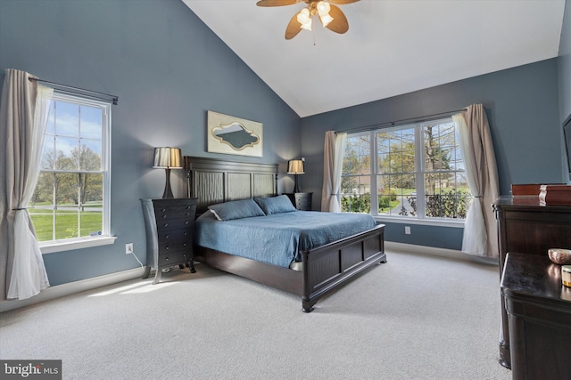 carpeted bedroom with high vaulted ceiling, ceiling fan, and baseboards