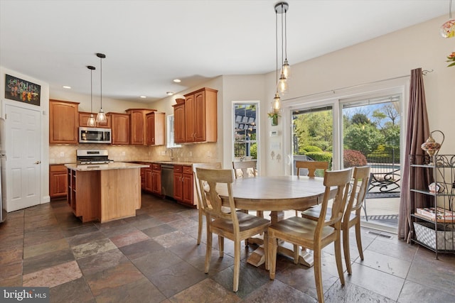dining space featuring visible vents, recessed lighting, and stone tile flooring