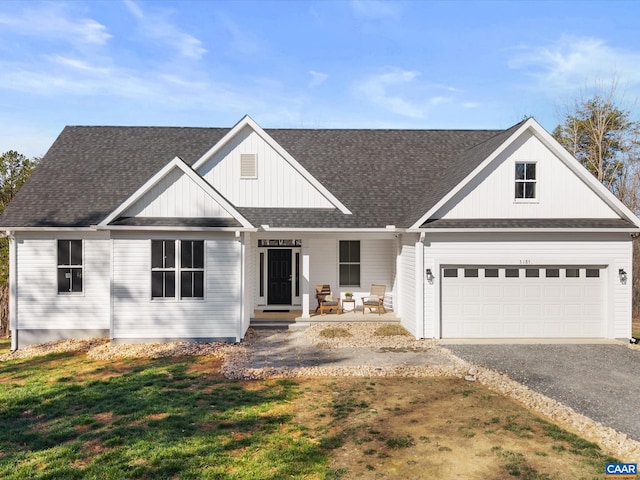 3185 Polecat Creek Ln, Scottsville, VA 24590 - view of front of property with driveway, covered porch, an attached garage, a shingled roof, and a front yard
