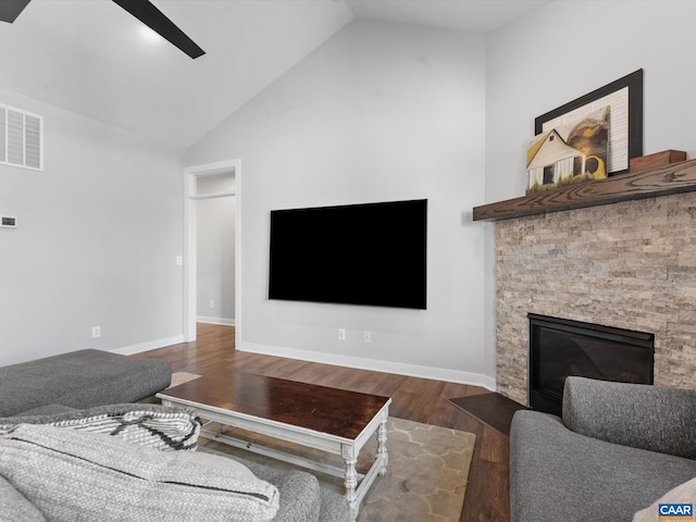 3185 Polecat Creek Ln, Scottsville, VA 24590 - living room featuring vaulted ceiling, a ceiling fan, a stone fireplace, wood finished floors, and visible vents