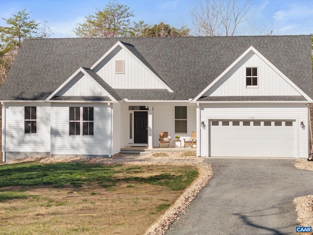 3185 Polecat Creek Ln, Scottsville, VA 24590 - modern inspired farmhouse with aphalt driveway, board and batten siding, an attached garage, a porch, and a front yard
