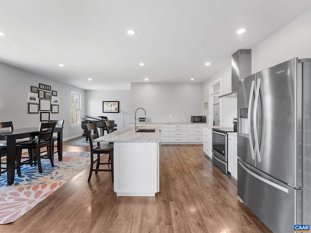 3185 Polecat Creek Ln, Scottsville, VA 24590 - kitchen with a sink, a center island with sink, wall chimney exhaust hood, appliances with stainless steel finishes, and dark wood-style floors