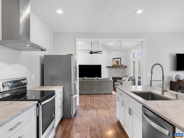 3185 Polecat Creek Ln, Scottsville, VA 24590 - kitchen with stainless steel appliances, a sink, dark wood-style flooring, ceiling fan, and wall chimney range hood