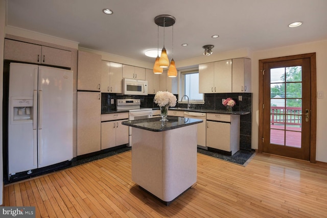 kitchen with white appliances, backsplash, light wood finished floors, recessed lighting, and crown molding