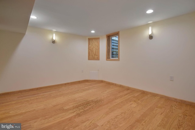 finished basement featuring wood finished floors, recessed lighting, and baseboards