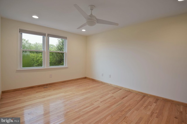 unfurnished room with light wood-style floors, a ceiling fan, baseboards, and recessed lighting