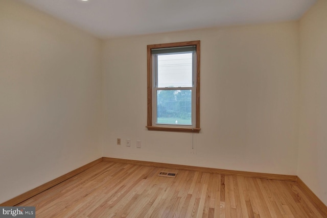unfurnished room featuring light wood finished floors and baseboards