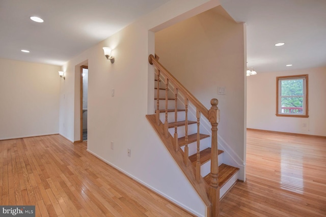 staircase featuring hardwood / wood-style floors, recessed lighting, and baseboards