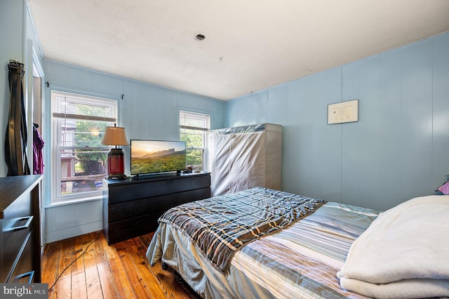 bedroom with hardwood / wood-style floors