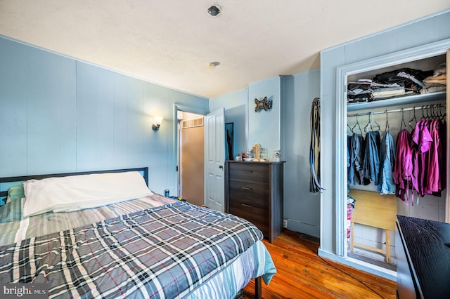 bedroom featuring wood finished floors and a closet
