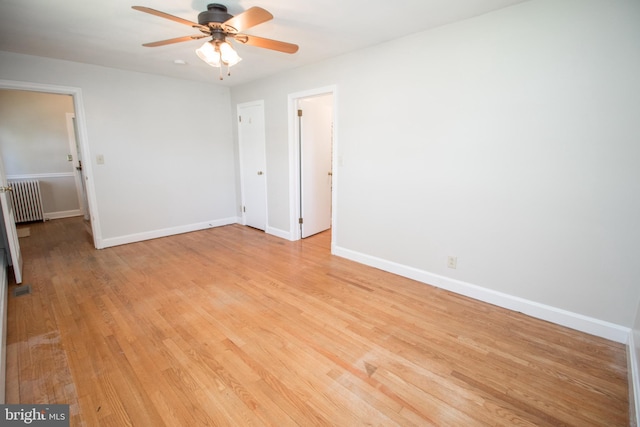 23075 Hollywood Rd, Leonardtown, MD 20650 - spare room with a ceiling fan, baseboards, light wood-style floors, and radiator