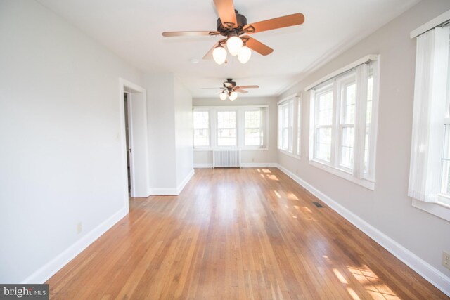 23075 Hollywood Rd, Leonardtown, MD 20650 - unfurnished room featuring radiator, baseboards, a ceiling fan, and light wood-style floors