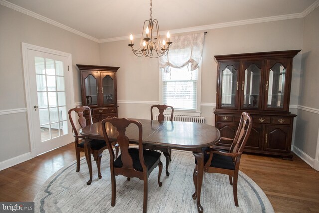 23075 Hollywood Rd, Leonardtown, MD 20650 - dining room featuring wood finished floors, crown molding, baseboards, and a notable chandelier