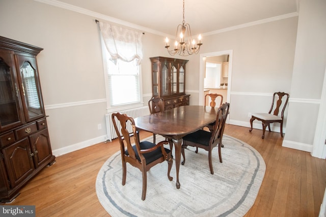 23075 Hollywood Rd, Leonardtown, MD 20650 - dining room with radiator heating unit, light wood finished floors, an inviting chandelier, ornamental molding, and baseboards