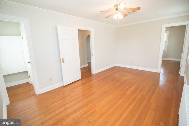 23075 Hollywood Rd, Leonardtown, MD 20650 - interior space with visible vents, ornamental molding, arched walkways, light wood-style floors, and baseboards