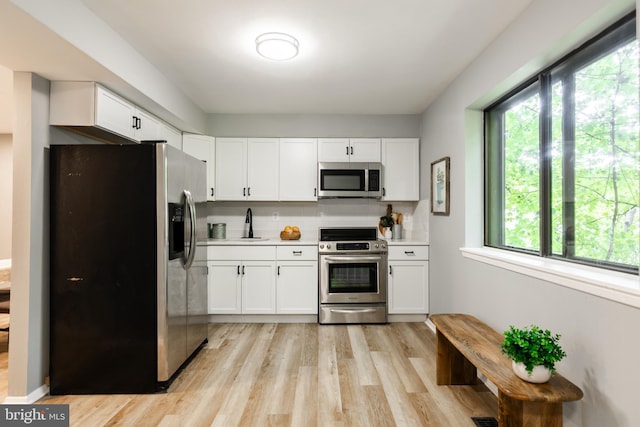 7374 Hickory Log Cir, Columbia, MD 21045 - kitchen with appliances with stainless steel finishes, plenty of natural light, white cabinets, and light countertops