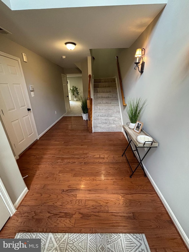 6733 Emmanuel Ct, Gainesville, VA 20155 - corridor featuring wood finished floors, stairs, and baseboards